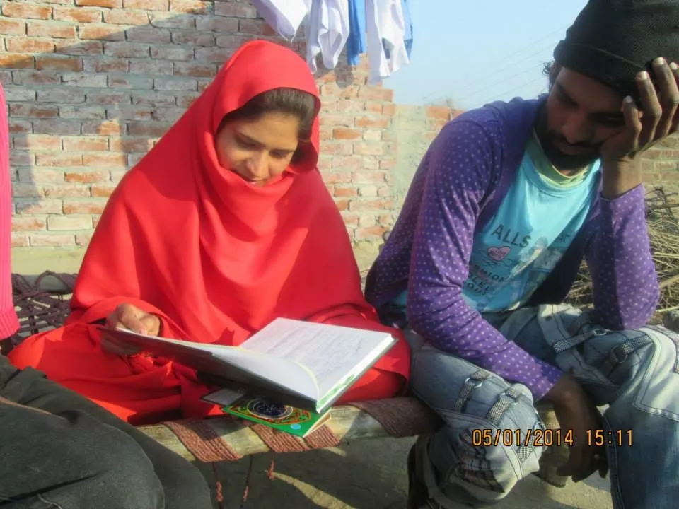 Church volunteers teaching children in a community education program
